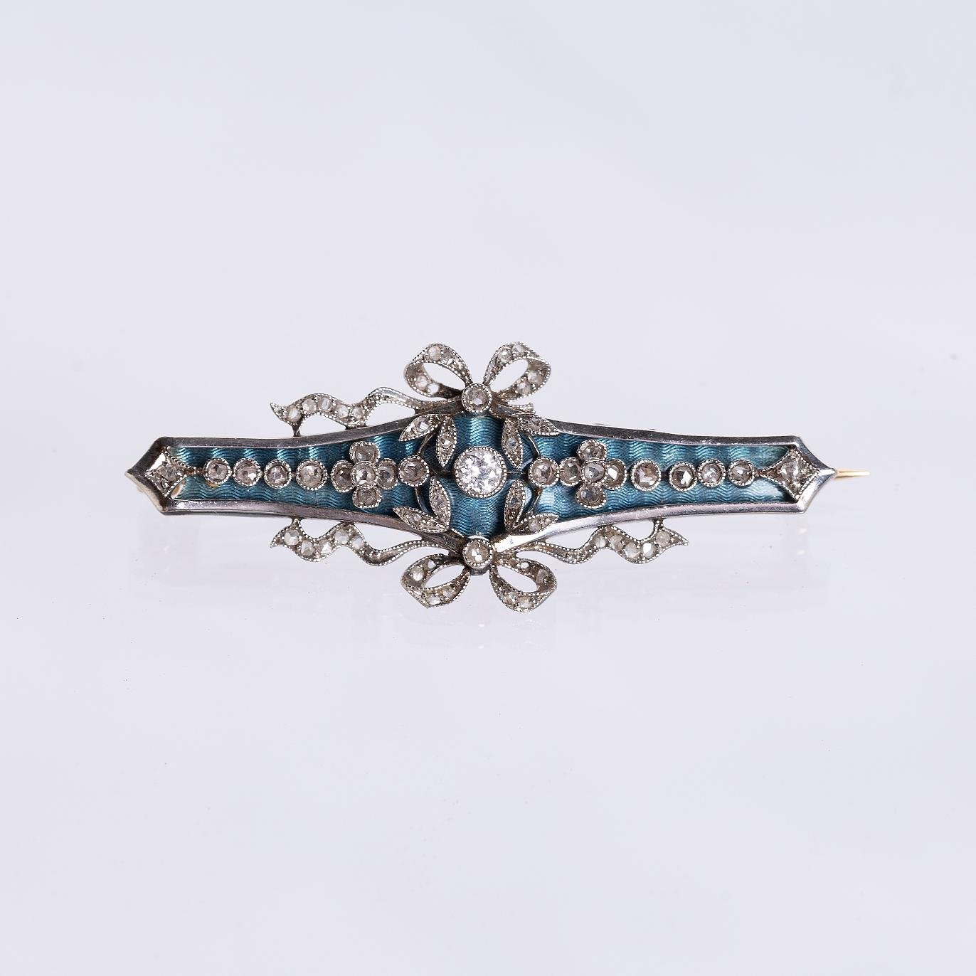 Prendedor en oro 18 K con brillante y diamantes